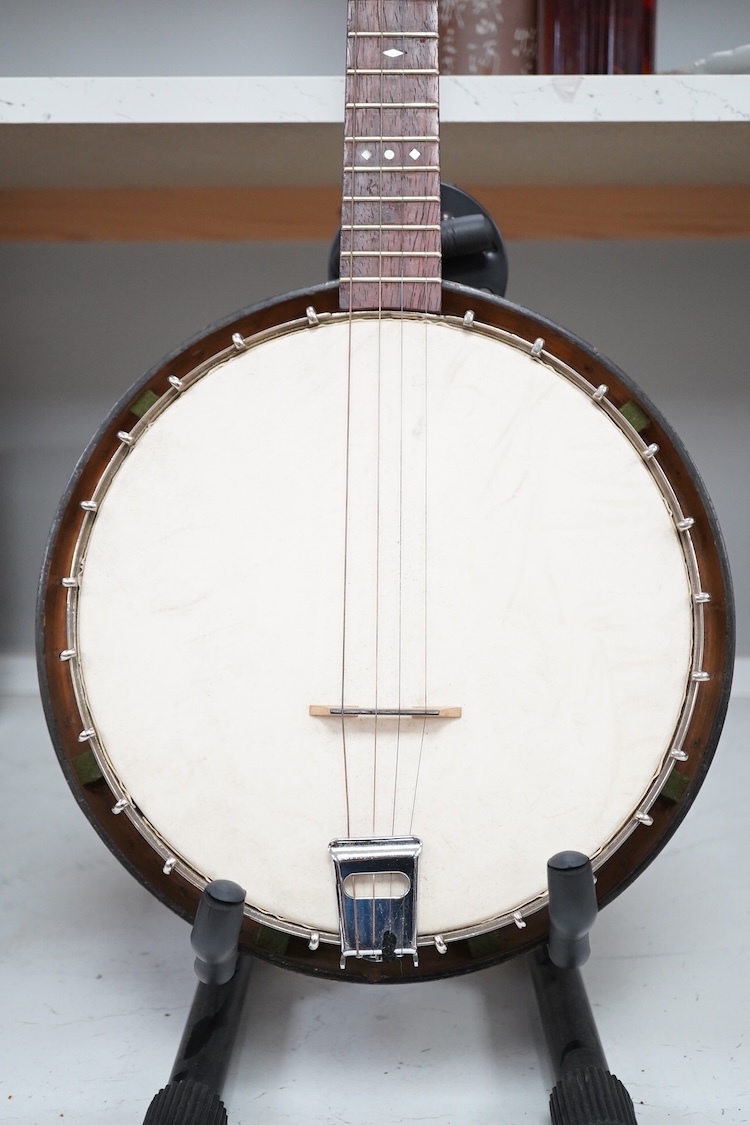 A cased Vega 4-string tenor banjo stamped M. Roccia, steel body with veneered back, the case embossed with; Ronald Quilter, 10, Cadogan Lane, London S.W.1., overall length 82cm